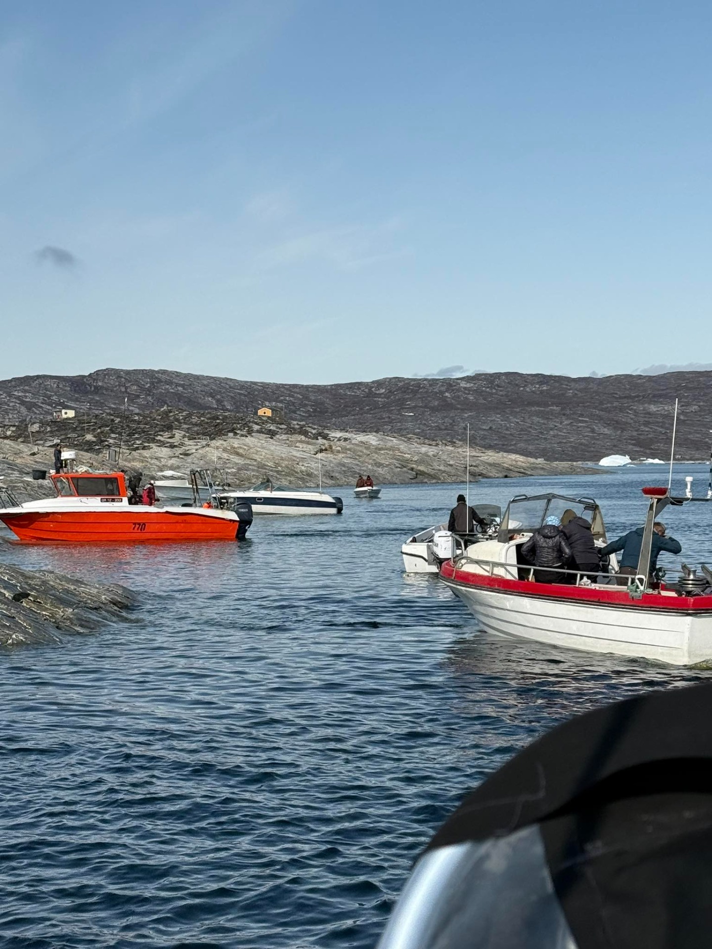 Experience traditional Greenlandic boat fishing and catch fresh fish for dinner on a peaceful trip at sea, using handline fishing surrounded by silence, Arctic nature, and clear ocean views.